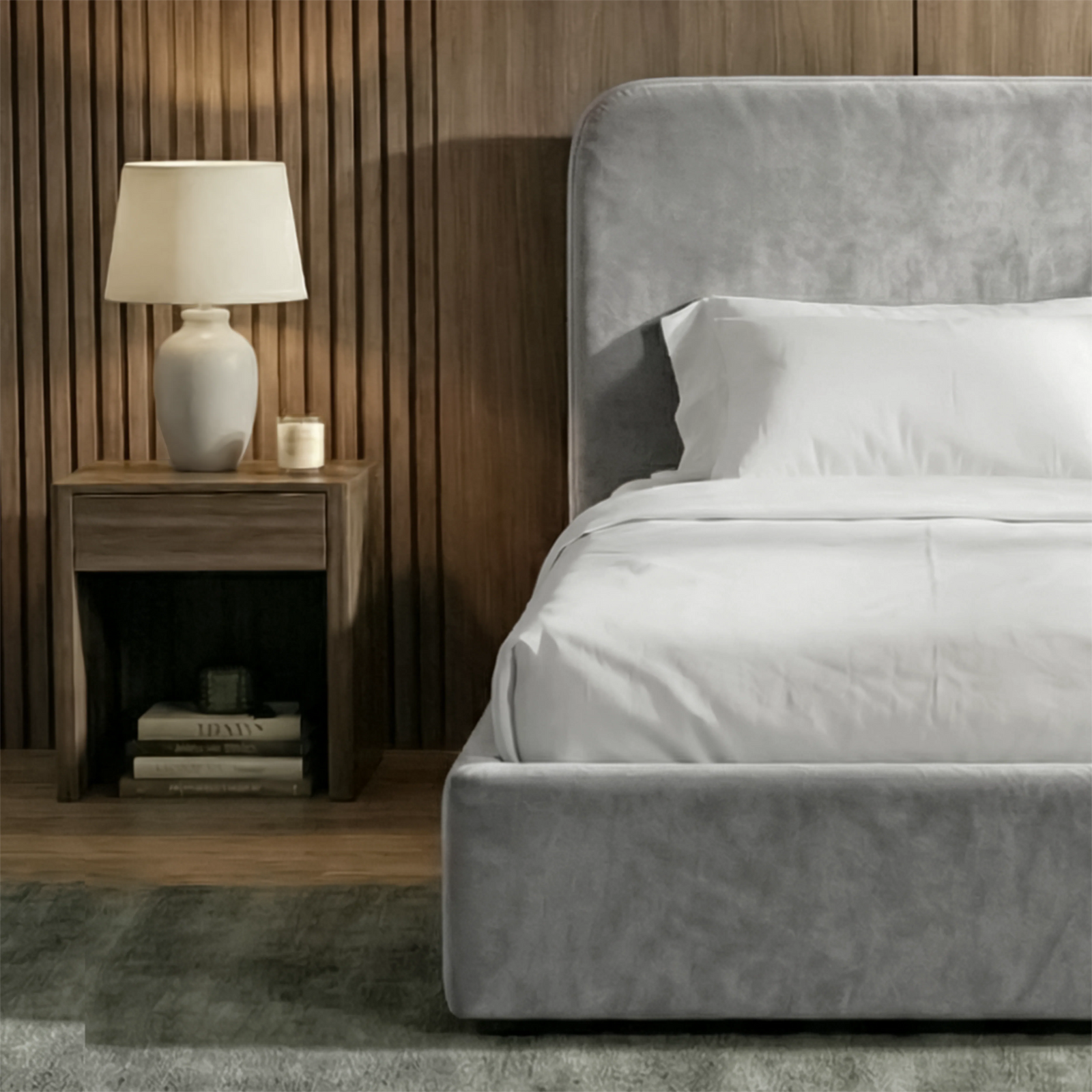 [Single | Light Grey] Head-on shot of Pluva velvet bed with curved headboard symmetric between two lit bedside lamps
