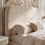 [King | Beige] Pluva ottoman bed padded headboard viewed up close with soft velvet texture and two pillows at base