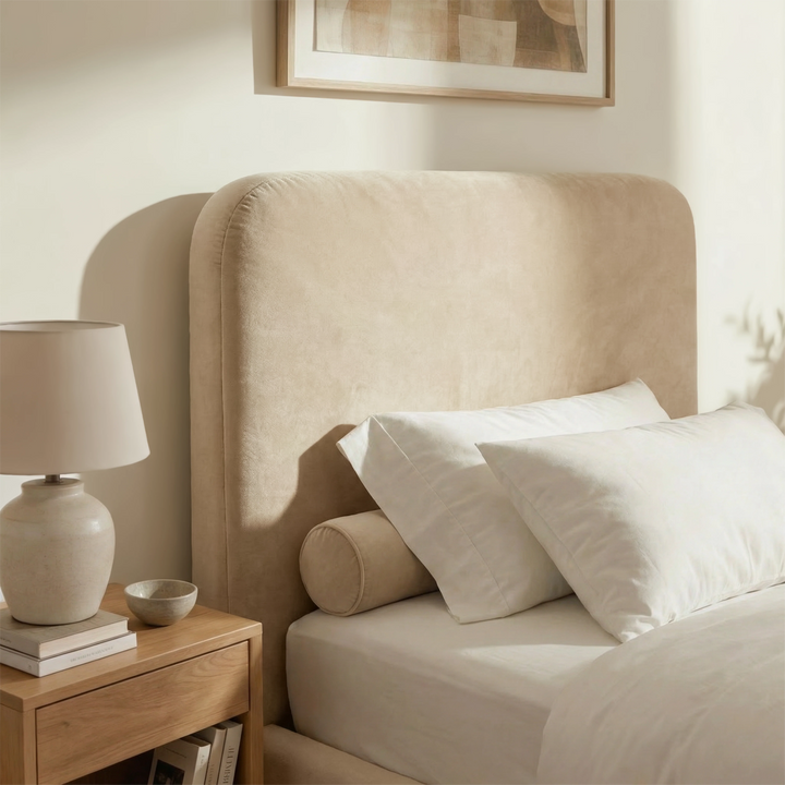 [Single | Beige] Single beige Pluva ottoman bed headboard close-up, curved profile, velvet texture and panel stitching