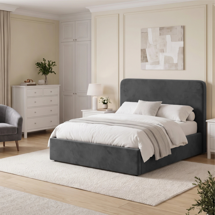 [Double | Grey] Wide bedroom setting with rounded headboard, fitted wardrobe, chest of drawers, armchair and rug