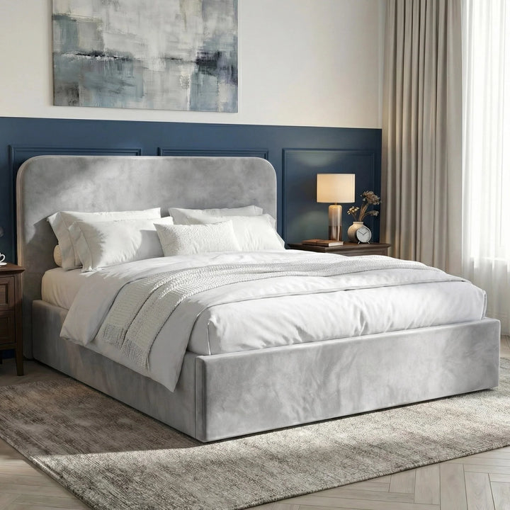[Double | Light Grey] Bedroom scene featuring Pluva velvet ottoman storage bed with quilted throw and layered pillows