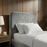 [Single | Light Grey] Close-up of Pluva ottoman storage bed headboard in light grey velvet with two white pillows