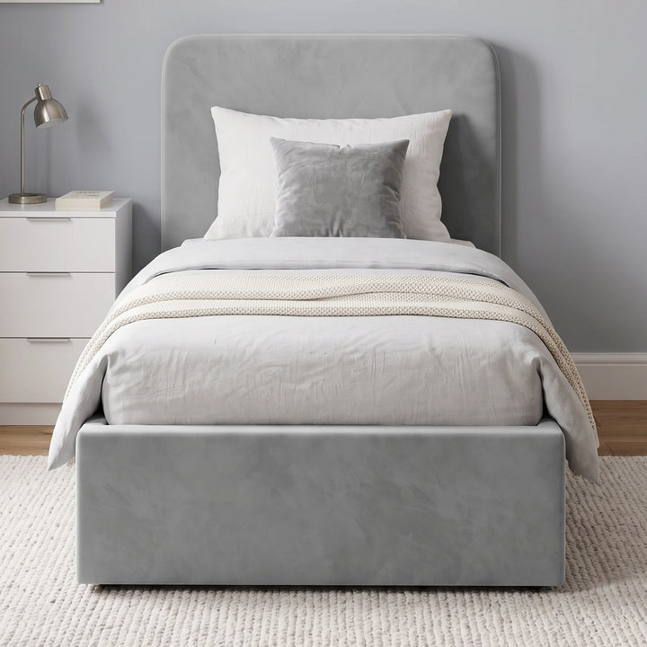 [Single | Light Grey] Front-on bedroom view with rounded headboard, white bedding, bedside cabinet and wall art