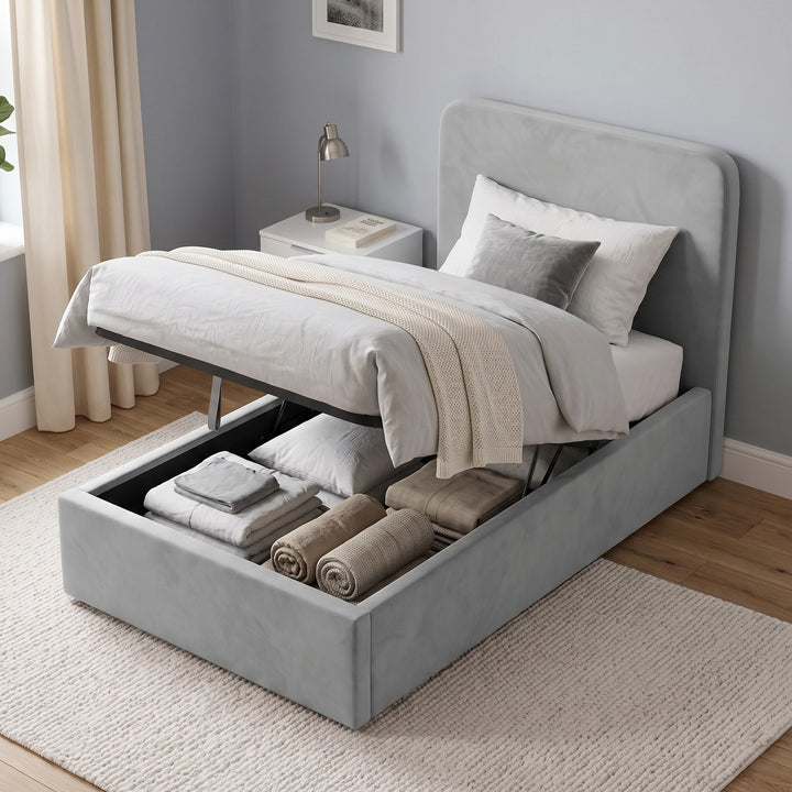 [Single | Light Grey] Ottoman base raised on gas struts showing stored pillows, folded bedding and rolled throws