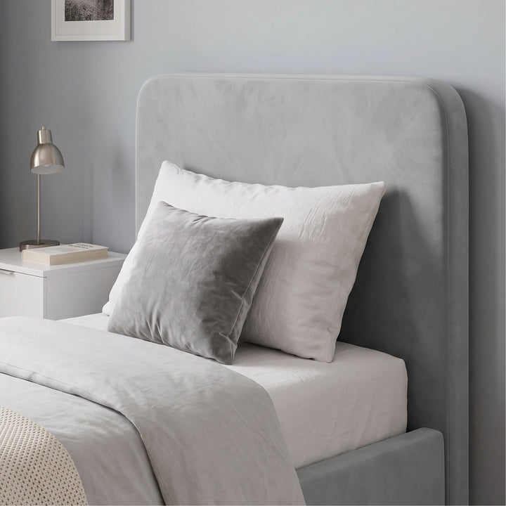 [Single | Light Grey] Headboard close-up with white pillows, square cushion, bedside lamp and framed wall print