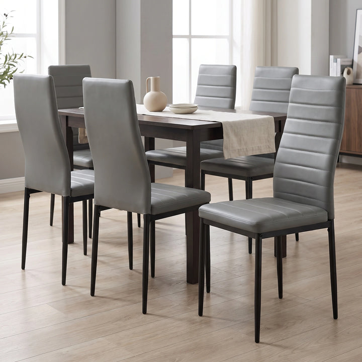 [Grey | Set of 6] PU leather dining chairs set around a wooden table in a bright dining room