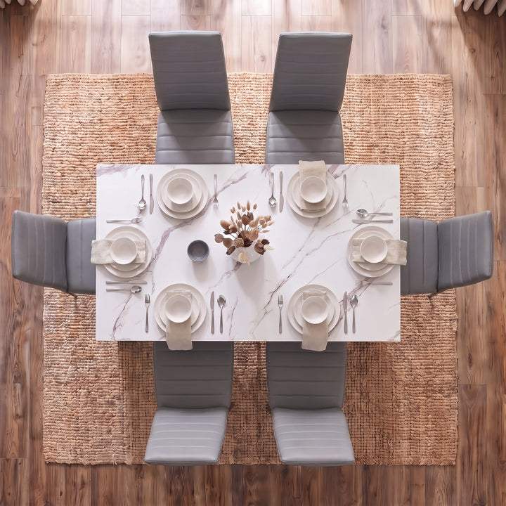 [6 Seater | Grey] Overhead view of a modern dining set featuring a rectangular white marble-patterned table surrounded by six gray upholstered chairs, set on a woven jute rug over a wood floor.