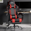 [Black + Red] Xstriker Gaming Chair With Footrest in black and red, placed in a modern home office setup with dual monitors and an adjustable desk.