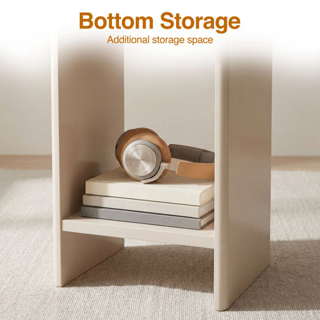 [Taupe] Bottom storage shelf of taupe round side table holding brown headphones on two stacked books