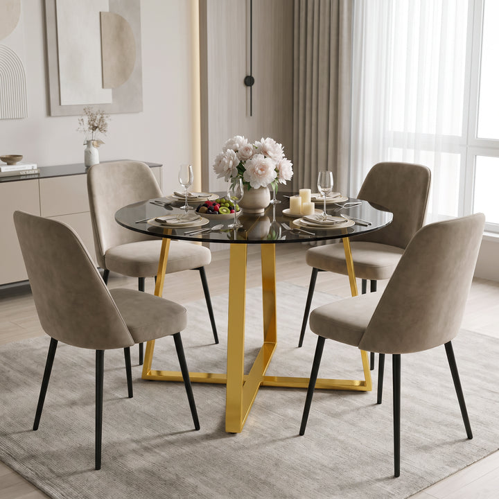 [Tinted] Round Tinted Glass Dining Table with Golden Colour Cross Legs styled with four chairs in a dining space.