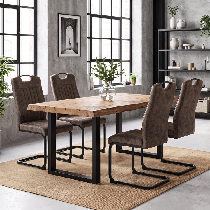[Rust Brown] Four high-back dining chairs with black loop frames around a wood table styled with a plant vase.