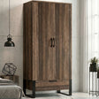 [Rust Wood] Rustvale wardrobe in bedroom with closed doors, lower drawer, black metal legs, pendant light, bed, and plant.