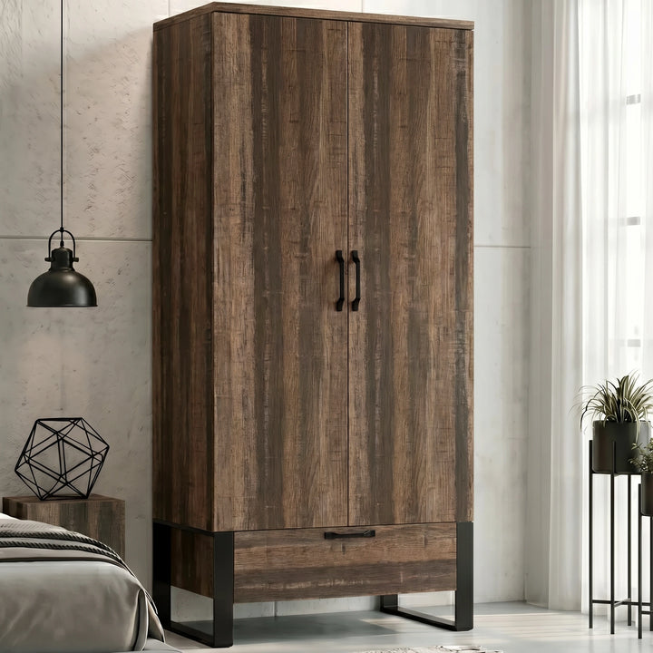 [Rust Wood] Rustvale wardrobe in bedroom with closed doors, lower drawer, black metal legs, pendant light, bed, and plant.
