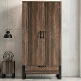 [Rust Wood] Rustvale wardrobe front view with closed double doors, lower drawer, black legs, pendant light, and side table.