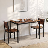 [Rustic] Breakfast table set of 2 with black metal frames, plates, cups, pastries, and napkins in a sunlit dining area.