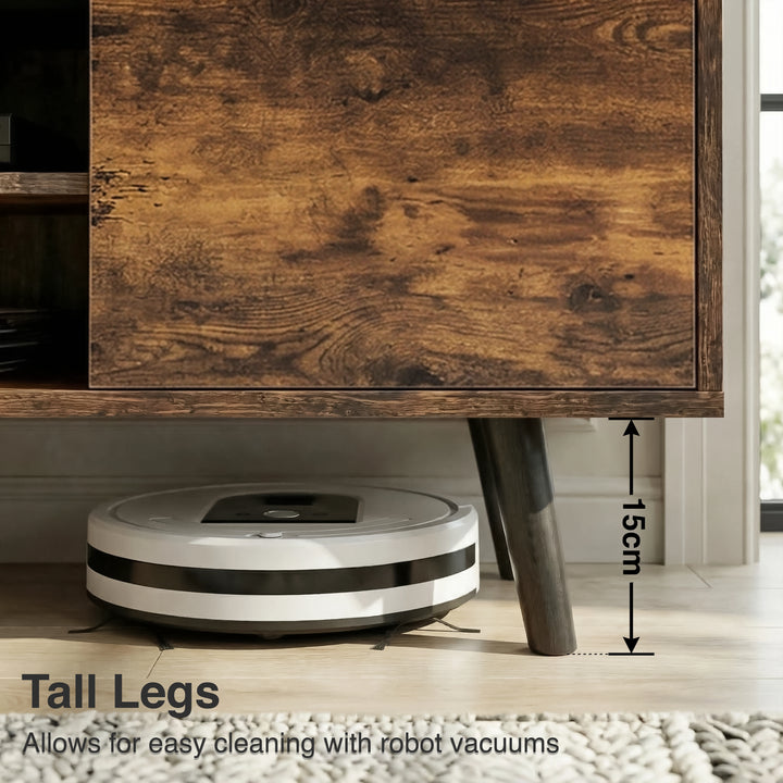 [Rustic] Larvik TV unit close-up of left cabinet door distressed-grain front beside tapered black leg with flooring below