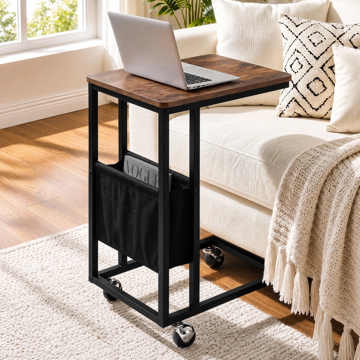 [Rustic] C-shaped side table by sofa with rustic wood-effect top, black frame, pouch, laptop and caster wheels