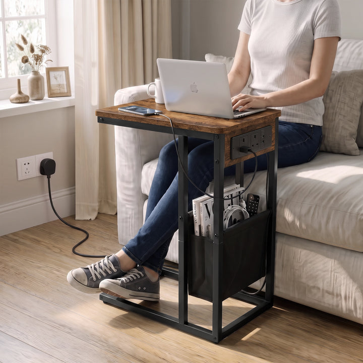 [Rustic] C-shaped side table used for laptop work by sofa with charging station plugged in wall socket and storage pouch