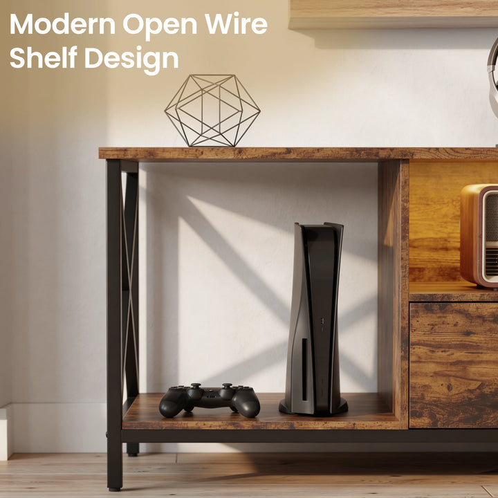 [Rustic] Calvera TV stand close-up of open wire shelf with a games console and controller inside, black X-frame legs and retro radio in the right shelf