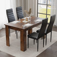 small dining table with black upholstered chairs adds charm to compact dining areas, ideal for warm and modern interiors