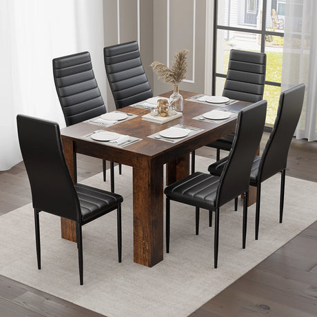 rustic dining table and 6 chairs shown from above with black cushioned seating and six full place settings