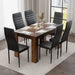 rustic dining table and 6 chairs shown from above with black cushioned seating and six full place settings