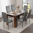 sleek modern dining table with chairs in grey leather, styled for compact spaces with warm rustic finishes