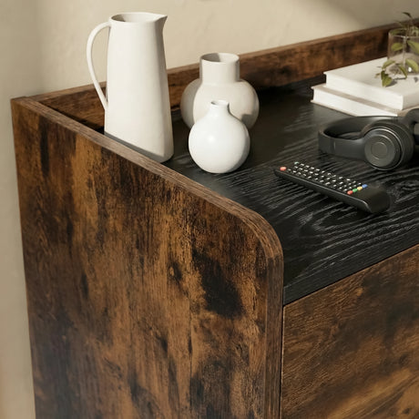[Rustic | 112 cm] Larvik close-up of dark woodgrain top with white ceramic jug, round vase, remote control, headphones, and curved rustic side edge
