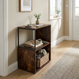[Rustic] This narrow side table stands in a hallway with a vase, folded textiles and a basket on its open shelves.