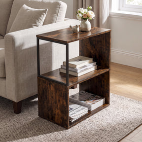 [Rustic] This narrow side table stands beside a sofa with flowers, books and magazines on its open shelves.