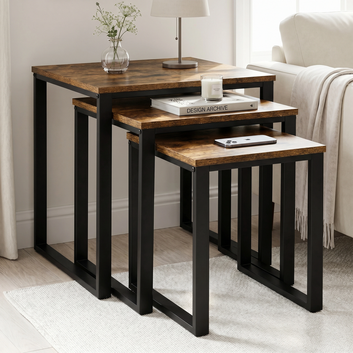 [Rustic] Stackora nest of tables set of 3 displayed in a bright living room corner with books, candle, and phone on each surface
