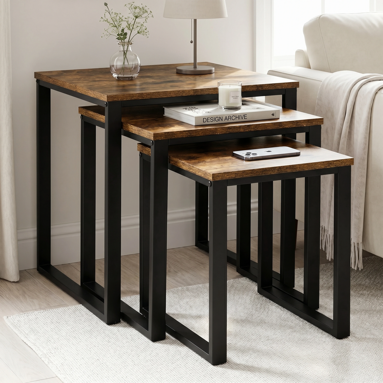 [Rustic] Stackora nest of tables set of 3 displayed in a bright living room corner with books, candle, and phone on each surface