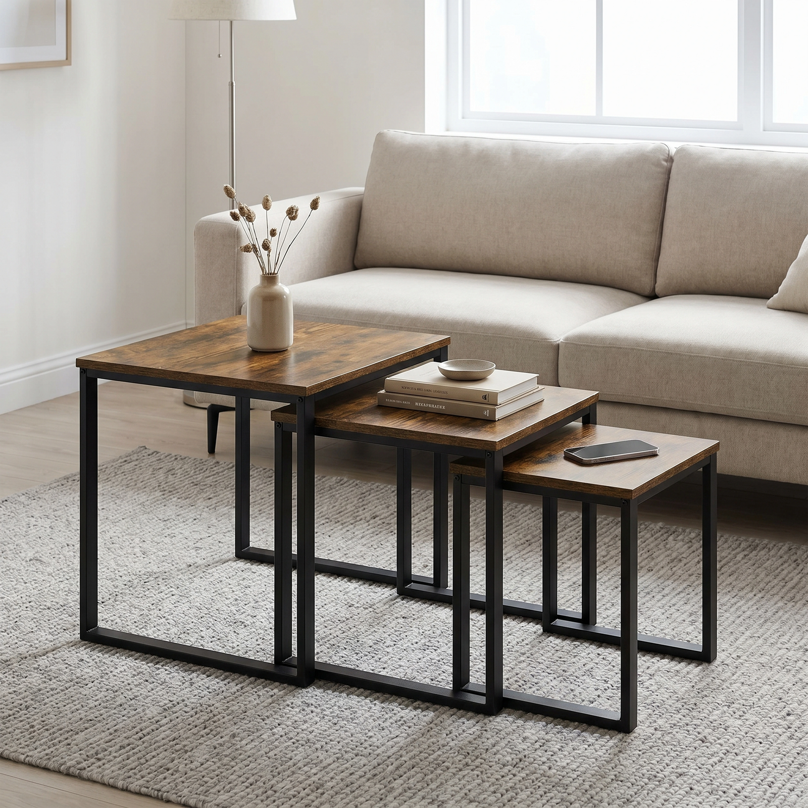[Rustic] Stackora nest of tables set of 3 arranged in a living room with sofa, rug, and decorative items styled across all three surfaces