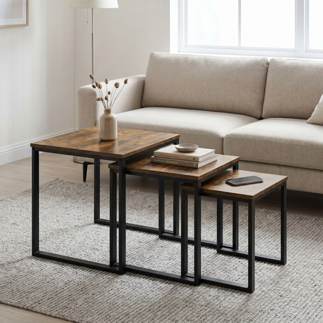 [Rustic] Stackora nest of tables set of 3 arranged in a living room with sofa, rug, and decorative items styled across all three surfaces