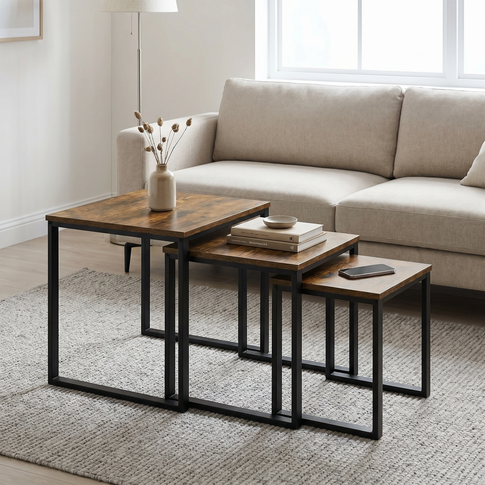 [Rustic] Stackora nest of tables set of 3 arranged in a living room with sofa, rug, and decorative items styled across all three surfaces