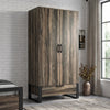 [Rustic Dark Wood] Rustvale wardrobe in bedroom with closed doors, lower drawer, black metal legs, pendant light, bed, and plant.