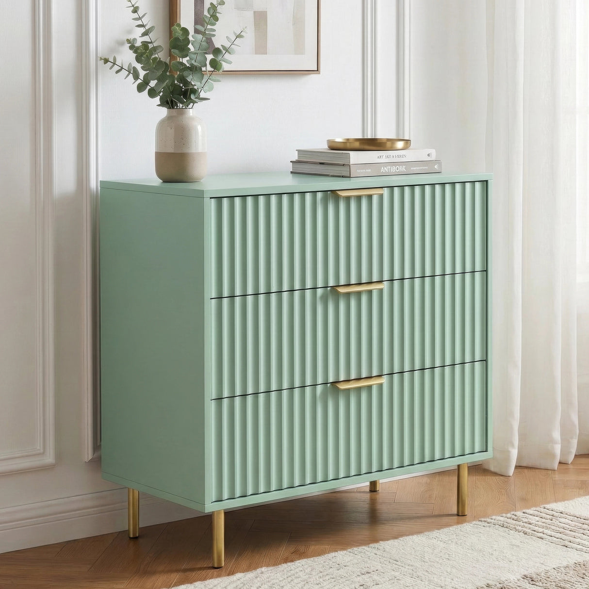 [Sage Green] Front view of green bedroom drawers with aligned golden handles and structured panel design