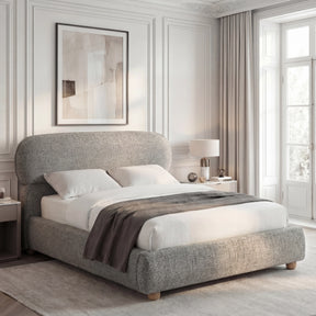 [Double | Grey] Woven fabric bed from the side with rounded headboard and grey throw beside window with sheer curtains