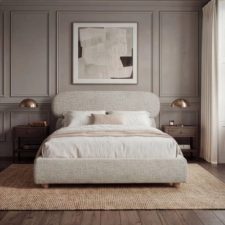 [King | Camel] Front view of upholstered bed with pill-shaped headboard centred between matching nightstands with lamps
