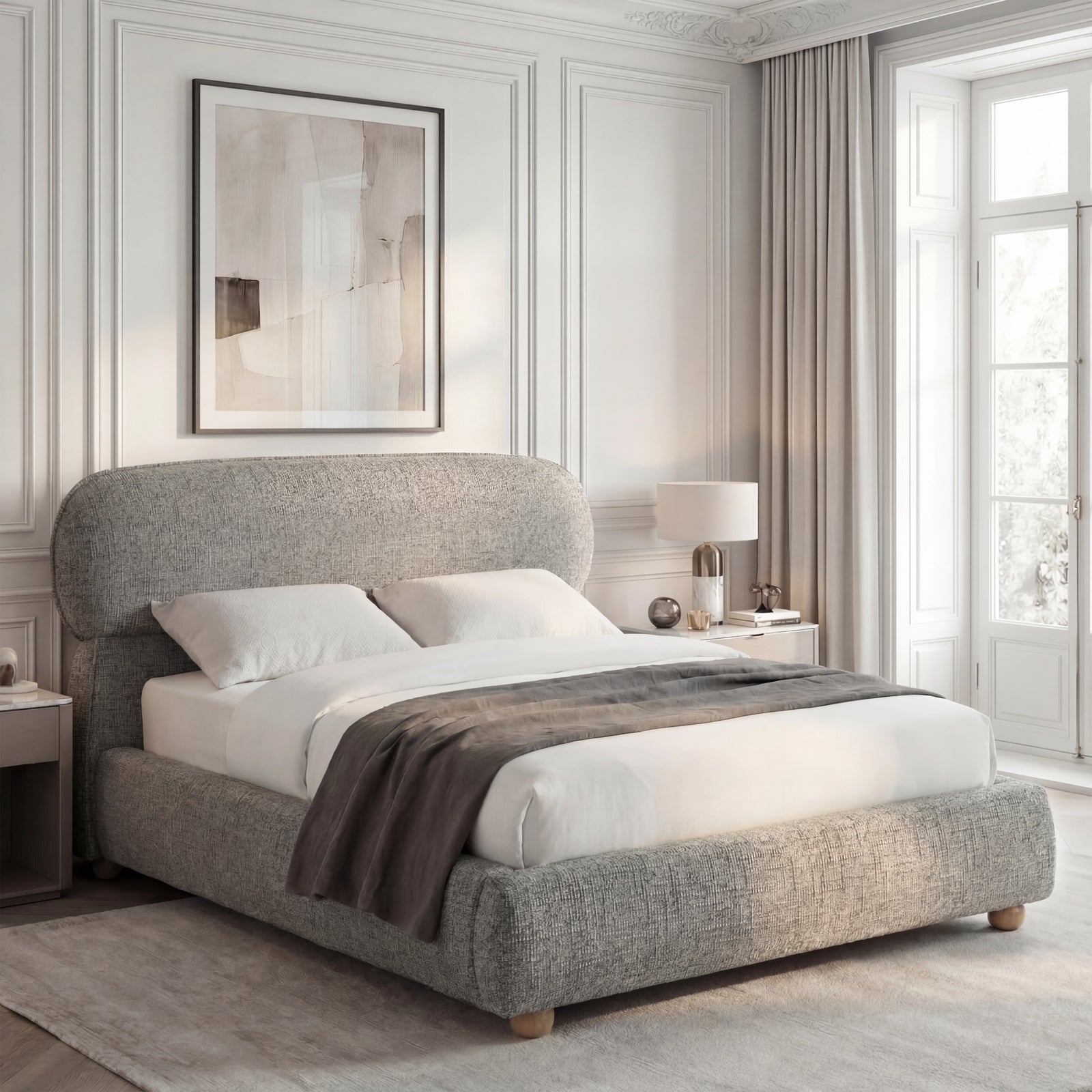 [King | Grey] Side angle of upholstered bed with pill-shaped padded headboard and low-profile footboard on wooden ball feet