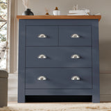 [Blue] Shaker chest of drawers in navy blue with vase decor on the oak top and panelled wall behind