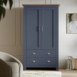 [Blue] Front view of navy blue wardrobe in Shaker style, central chrome bar handles between the doors
