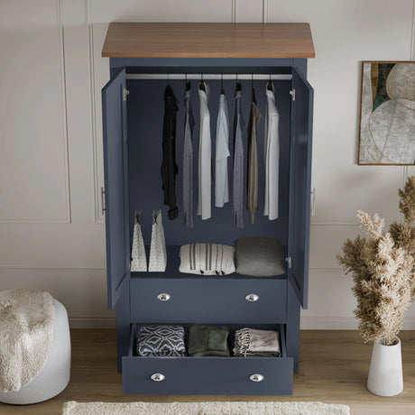 [Blue] Open view of navy blue Shaker wardrobe with garments hanging and folded throws inside drawer