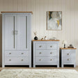 [Grey] Grey wardrobe, chest and bedside lined up with framed botanical art on panelled wall behind chest