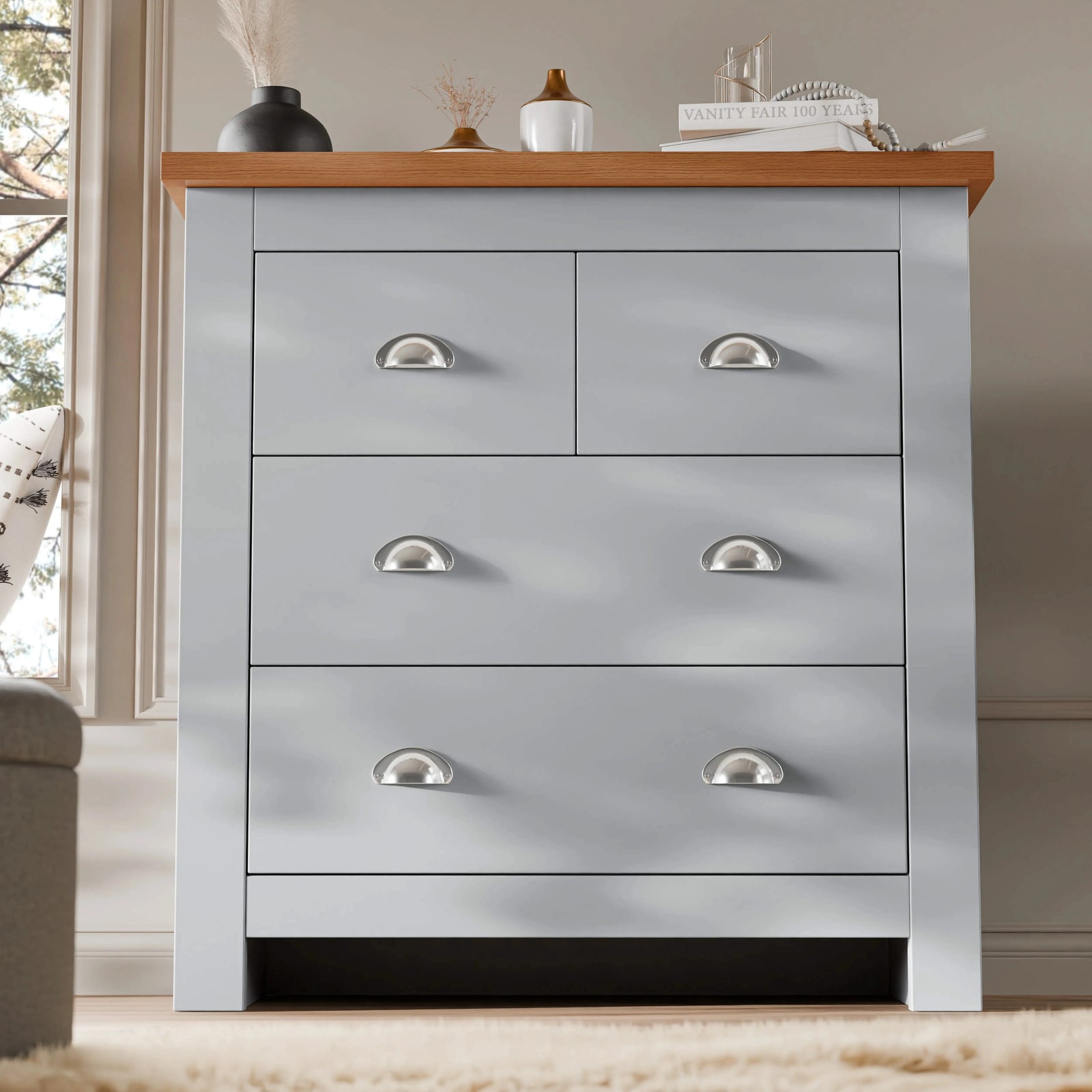 [Grey] Grey four drawer chest with vase and books matching Shaker bedroom furniture set on rug