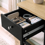 [Black] Close-up of the open drawer holding glasses, books and small bedside essentials