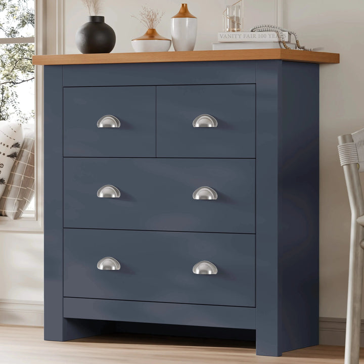 [Blue] Navy blue Shaker chest of drawers near window, oak top with vases and books, silver cup-shaped pulls