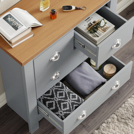 [Grey] Grey Shaker chest of drawers open, folded clothes and patterned cushion inside, magazines, oak top