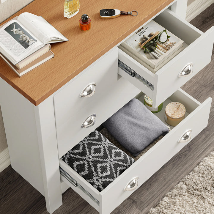 [White] White Shaker chest of drawers fully open overhead, magazines in small drawer, cushion in wide drawer