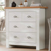 [White] Shaker chest of drawers angled by bedroom window, oak top with vases, silver cup handles, white frame